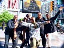 Cheryl And Band In Front Of Billboard
